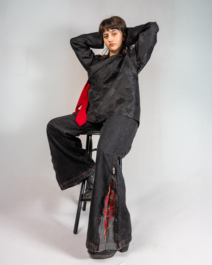 Model wearing Black Year of Snake jeans, showcasing style and unique design elements in a fashion shoot.