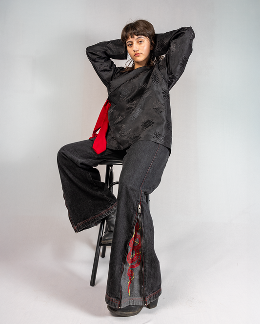 Model wearing Black Year of Snake jeans, showcasing style and unique design elements in a fashion shoot.