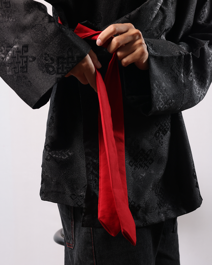 Wonju kimono shirt with red tie detail and black patterned fabric.